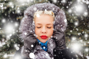 Blond girl in fur coat outdoors