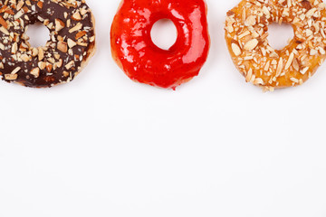 Delicious donuts with chocolate almond, strawberry jam and almond caramel glazed, Isolated on white background. Selective focus.