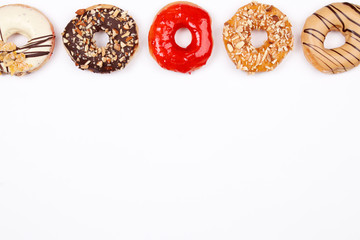 Delicious donuts with chocolate almond, strawberry jam, peanut butter, white chocolate and almond caramel glazed, Isolated on white background. Selective focus.