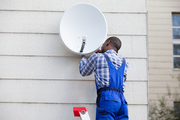 Man In Uniform Fitting TV Satellite Dish