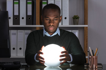Businessman Predicting Future With Crystal Ball