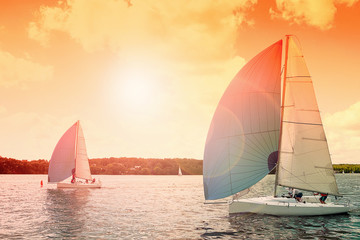 Sailing boat. Sailing yacht race, regatta.Sailboat at sunset. Recreational Water Sports, Extreme Sport Action. Healthy Active Lifestyle. Summer Fun Adventure. Hobby