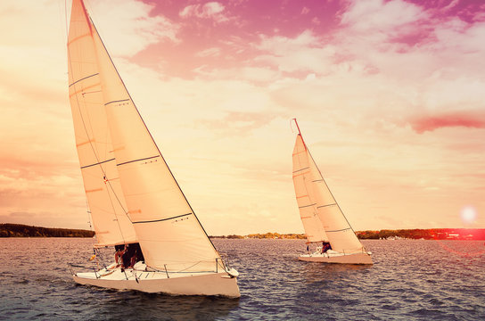 Sailing boat. Sailing yacht race, regatta.Sailboat at sunset. Recreational Water Sports, Extreme Sport Action. Healthy Active Lifestyle. Summer Fun Adventure. Hobby