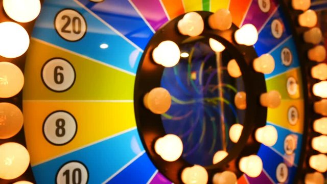 4K footage loop. retro colorful casino game cabinet flashing lights. game spinning light with bankrupt, success and fresh start slots. slot machine gamble footage background