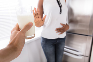Fototapeta na wymiar Woman Rejecting Glass Of Milk