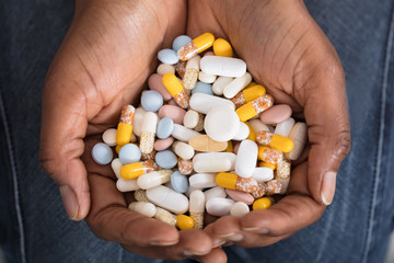 Human Hand With Variety Of Medicine Pills