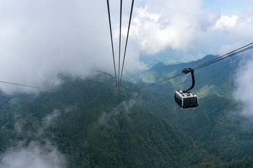 Cable car cabin high in the mountains with clouds