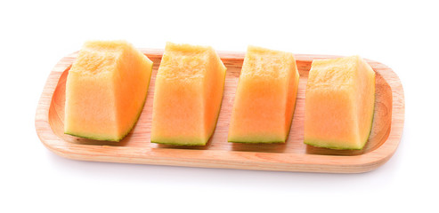 Fototapeta na wymiar Melon in a wooden dish on a white background