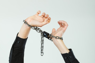 Man with chained hands, no freedom