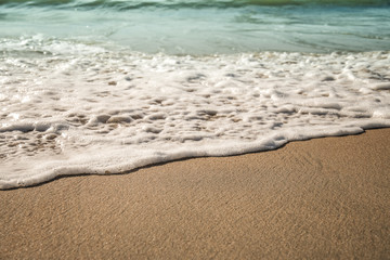 Fototapeta na wymiar Background soft wave of Sea with foam on sandy beach.