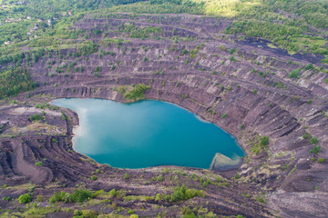 aerial view of deep mine lake in place of the mining pit