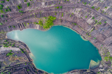 aerial view of deep mine lake in place of the mining pit