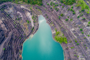 aerial view of deep mine lake in place of the mining pit
