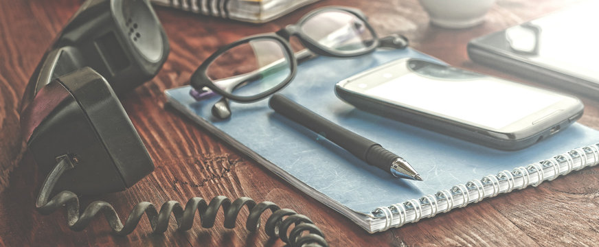workplace. notebooks with pens and glasses lie on a wooden table. modern office