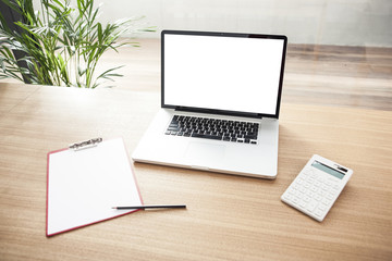 notebook with stationary on the wooden desk at the office.