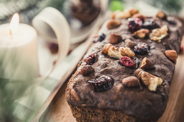 Beautiful tasty dried mixed nut Christmas fruit cake on wooden table
