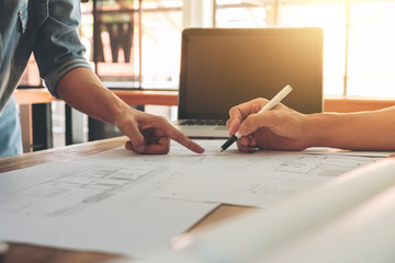 Image of engineer or architectural project, two engineering discussing and working on blueprint...