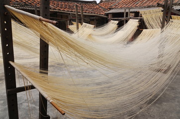Thin noodles drying on racks in Taiwan     