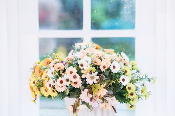 Flowers in vase on window