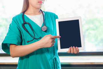 Young woman doctor with a Tablet.