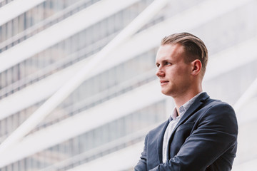 Portrait of handsome man in black suit standing outdoors