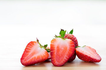 Closeup shot of fresh strawberries on wood table.
