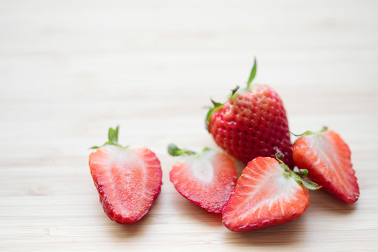 Closeup shot of fresh strawberries on wood table.