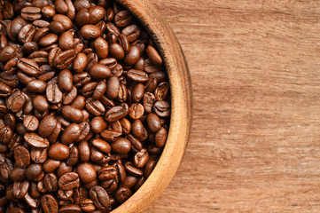 Close up of coffee beans in wooden bowl
