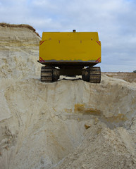 old abandoned yellow excavator in sandpit