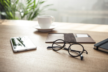 stationarys on the wood desk(table) at the day light.