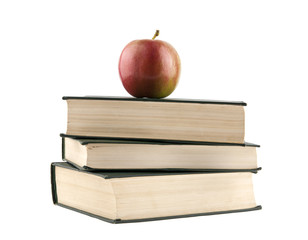 books and an apple isolated on a white background close-up