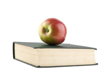 books and an apple isolated on a white background close-up