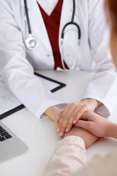 Hand Of Doctor  Reassuring Her Female Patient