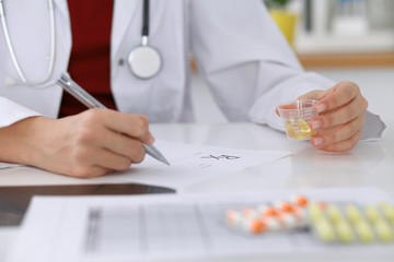 Female medicine doctor fills up  prescription form to patient closeup. Panacea and life save, prescribe treatment, legal drug store, contraception concept