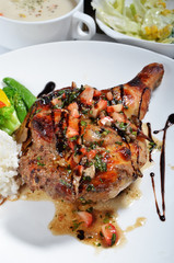 Closeup of roast chicken leg and rice