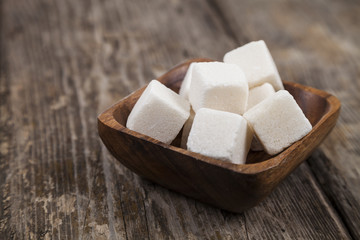 Sugar in a wooden bowl