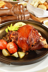 Roast pork knuckle on black pan