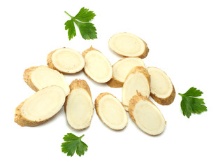 sliced horseradish root with parsley isolated on white background