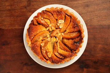 Freshly baked hot apple pie on wooden table          