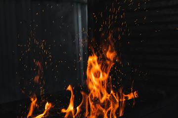 Fototapeta na wymiar Fire burning on the grill