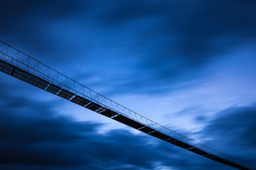 siluette rope bridge in the wind