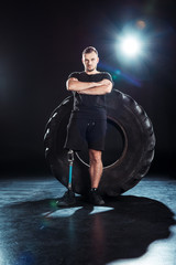 paralympic sportsman leaning on tire