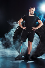 paralympic sportsman leaning on tire