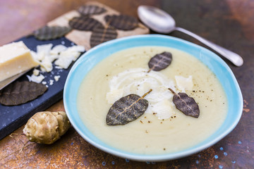 Cream soup of Jerusalem artichokes with herbs and parmesan.