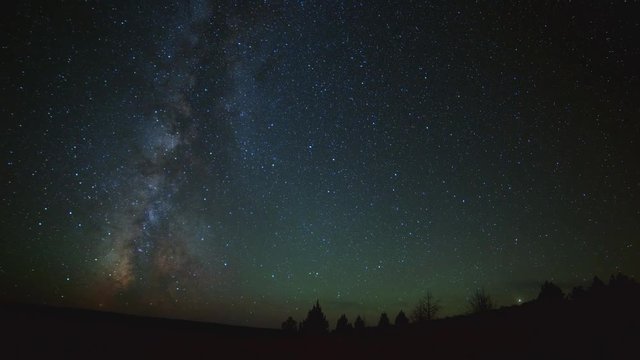 Milky way in desert with Western Juniper trees South Steens Mountain near Malheur National Wildlife Refuge
