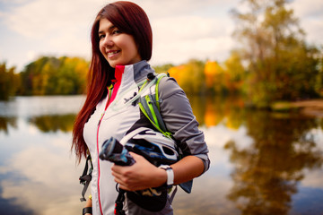 Picture of smiling woman with backpack and bicycle helmet