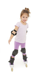 Little pretty girl riding a roller. Isolated on white background