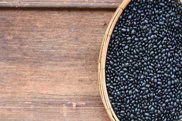 Black beans on wooden background