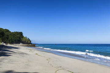 Low tide on a beautiful cloudless afternoon in Paga, Sikka Regency, East Nusa Tenggara, Indonesia.