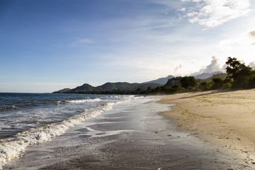 Waves wash onto an empty beach in Paga on the island of Flores in Indonesia.